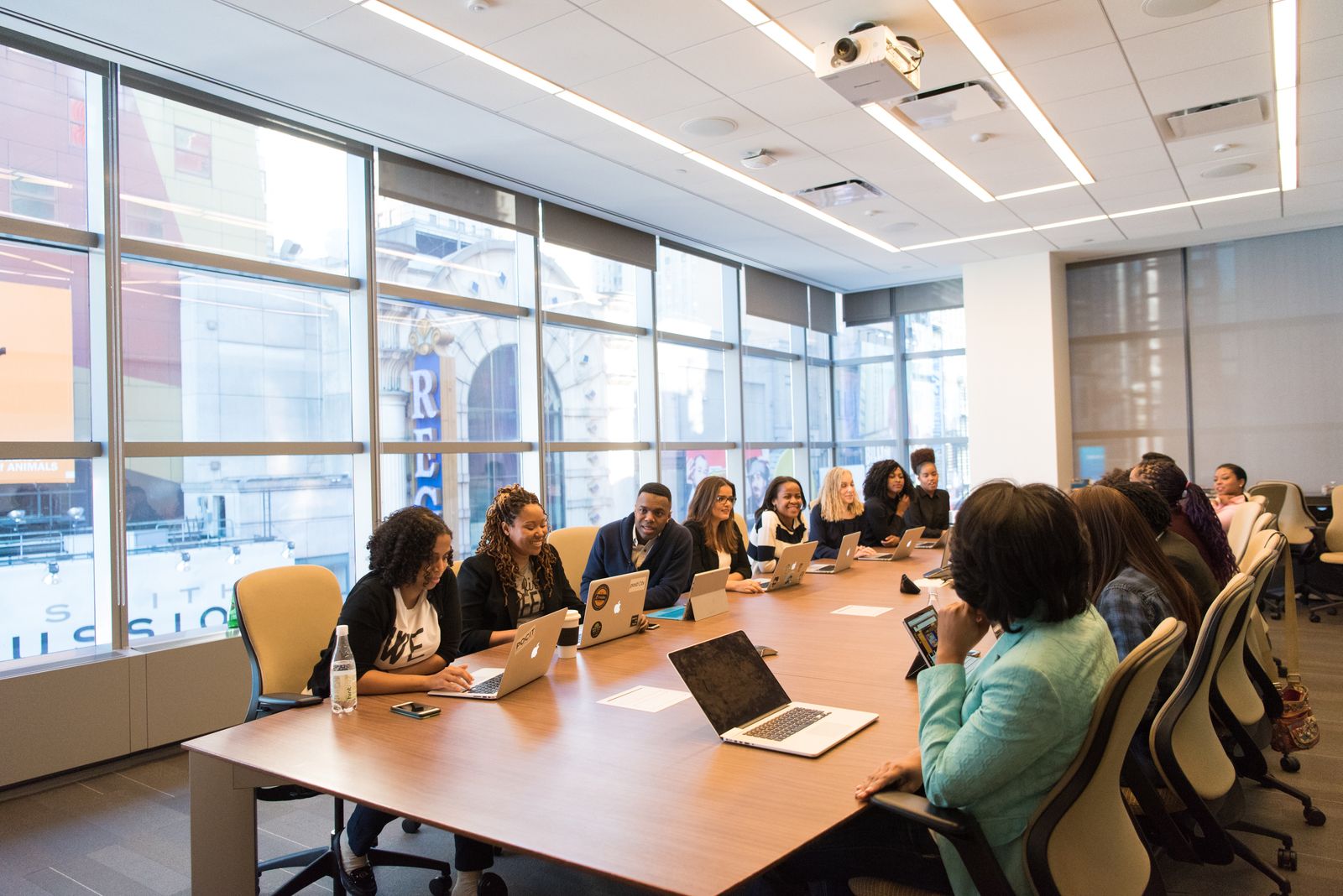 Professionals in serious discussion in a bright modern office, representative of a standing advisory conversation